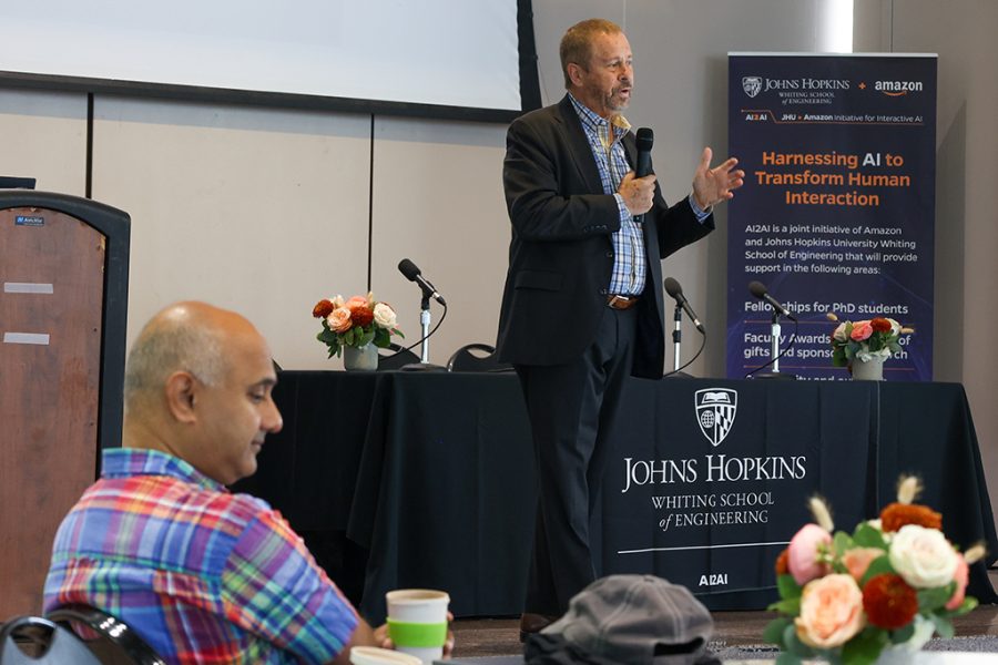Dean Ed Schlesinger stands onstage and speaks to the audience