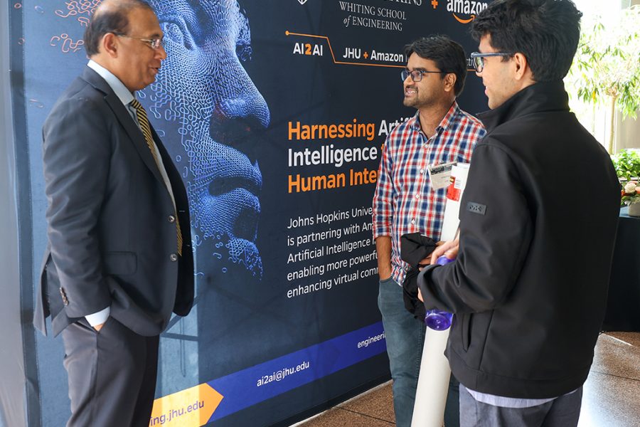 Mohamed Rehman, MD, Chair, Department of Anesthesia, Johns Hopkins All Children's Hospital, converses with 2023-2024 AI2AI Fellows Aniket Roy and Ambar Pal.
